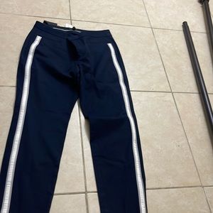 Navy blue with white stripes and 2 pockets in the back.